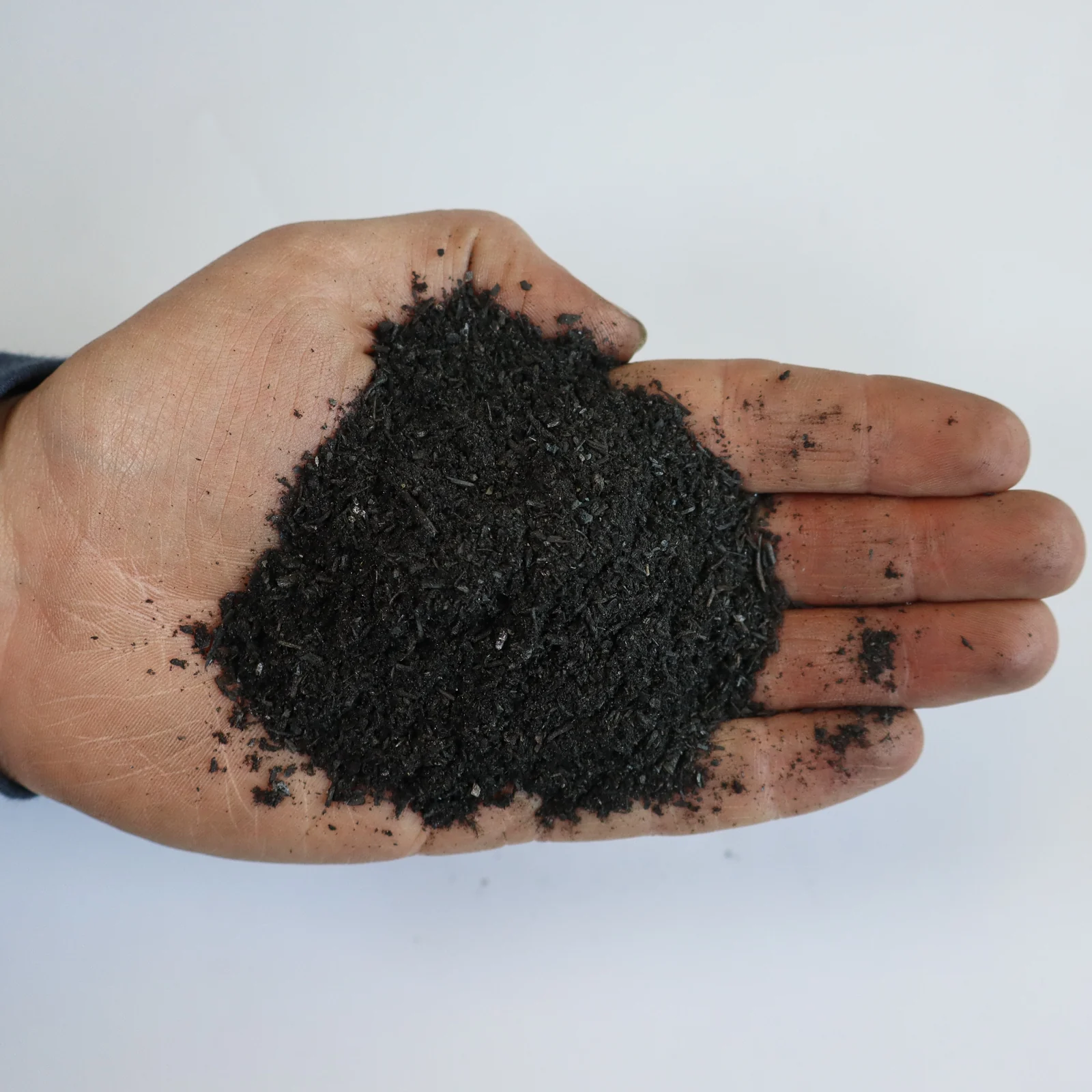 Hands holding Silvachar Biochar